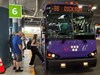 A purple WeGo bus marked 88 Dickson at station platform 6, with people boarding. The scene conveys a busy, routine, and organized transit environment.