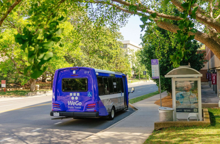 A WeGo Public Transit access van waits at a bus stop